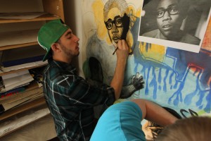 Cal U Student Dylan Winters works to finish the Hip-Hop mural April 2012.